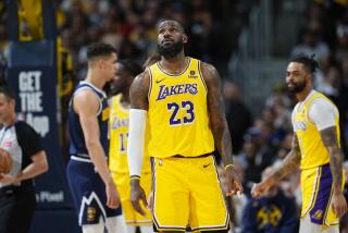 Los Angeles Lakers forward LeBron James (23) checks the scoreboard in the first half of Game 5.