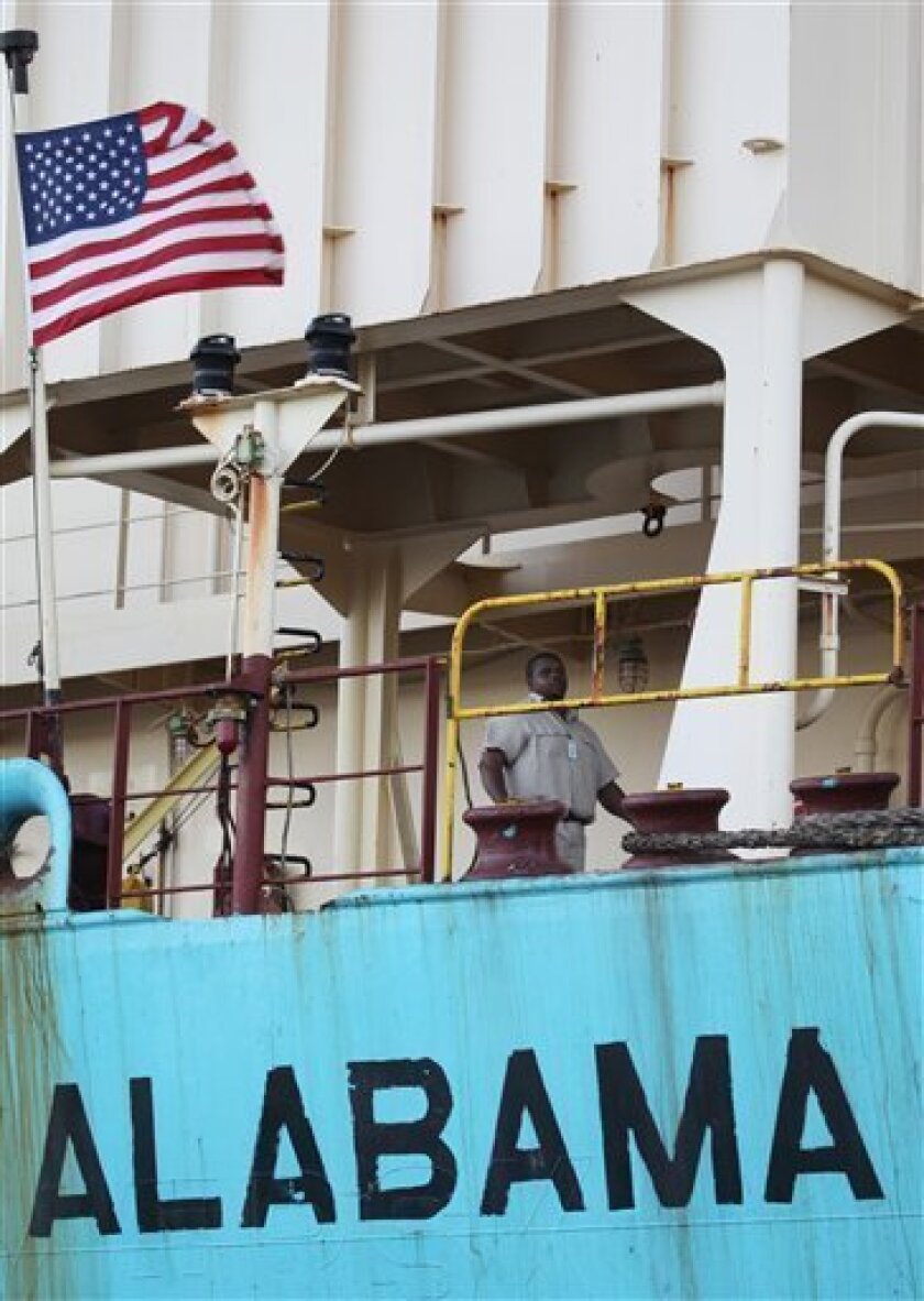 In this photo taken on April 12, 2009, A U.S, security agent walks on the deck of the Maersk Alabama in the port of Mombasa Kenya. A reader-submitted question about how cargo ships choose certain countries to flag their ships is being answered as part of an Associated Press Q&A column called "Ask AP".(AP Photo/Sayyid Azim)