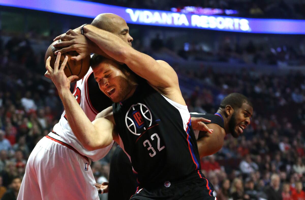 Clippers power forward Blake Griffin (32) fights for a rebound with Bulls power forward Taj Gibson in the first half.