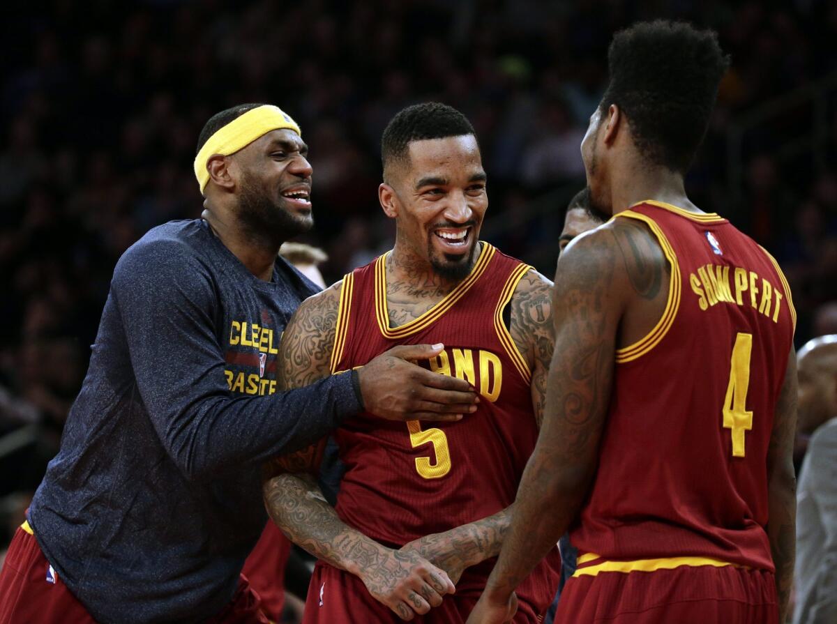 Cleveland's LeBron James, left, reacts to a dunk by teammate J.R. Smith against the New York Knicks on Feb. 22.