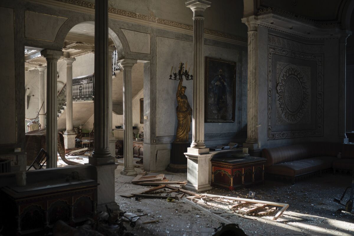 Broken glass and window frames lay on the floor of the Sursock Palace, heavily damaged after the explosion in the seaport of Beirut, Lebanon, Friday, Aug. 7, 2020. The level of destruction from the massive explosion at Beirut's port last week is ten times worse than what 15 years of civil war did. (AP Photo/Felipe Dana)