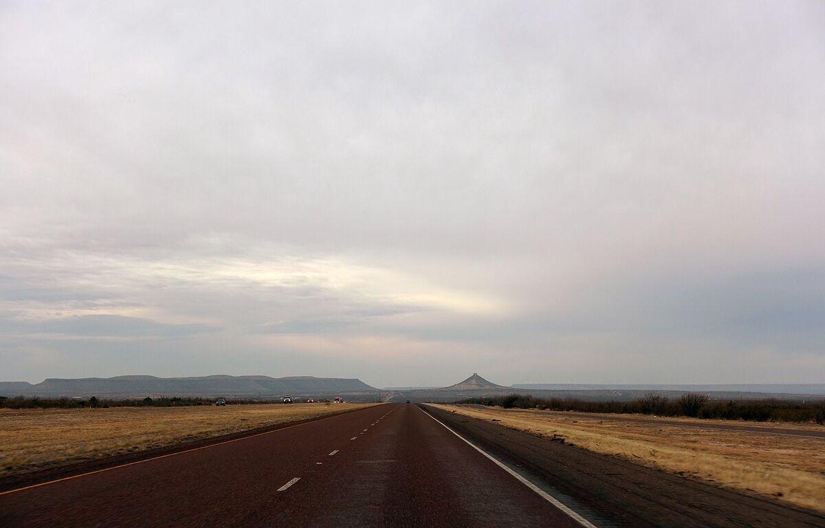 A straight road stretches to the horizon in West Texas