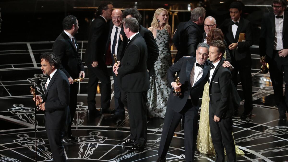 Director Alejandro Inarritu, center, accepts the award for best picture for "Birdman" with the cast and crew of the film.