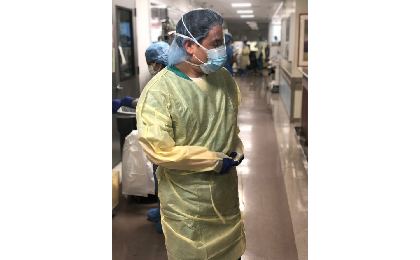 Dr. Glen Chun dons his personal protective equipment