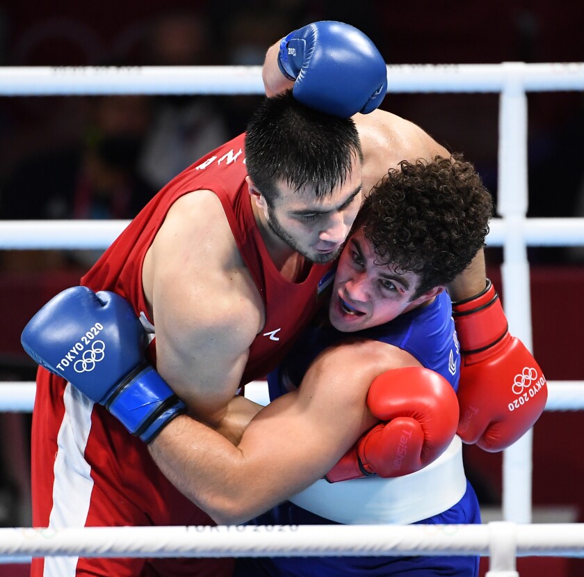 USA's Richard Torrez Jr., blue, battles Uzbekistan's Bakhodir Jalolov.