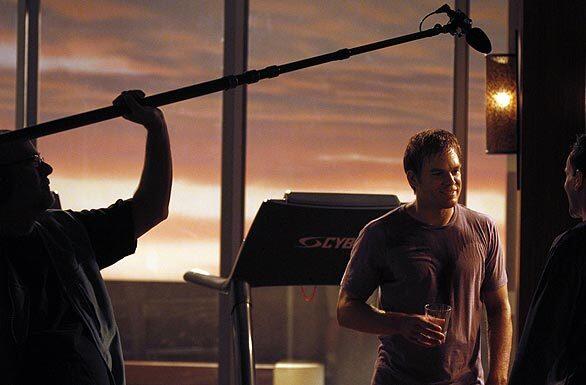 Michael C. Hall, "Dexter," and guest star Jonny Lee Miller talk during scene while filming in the gym on the set of "Dexter."
