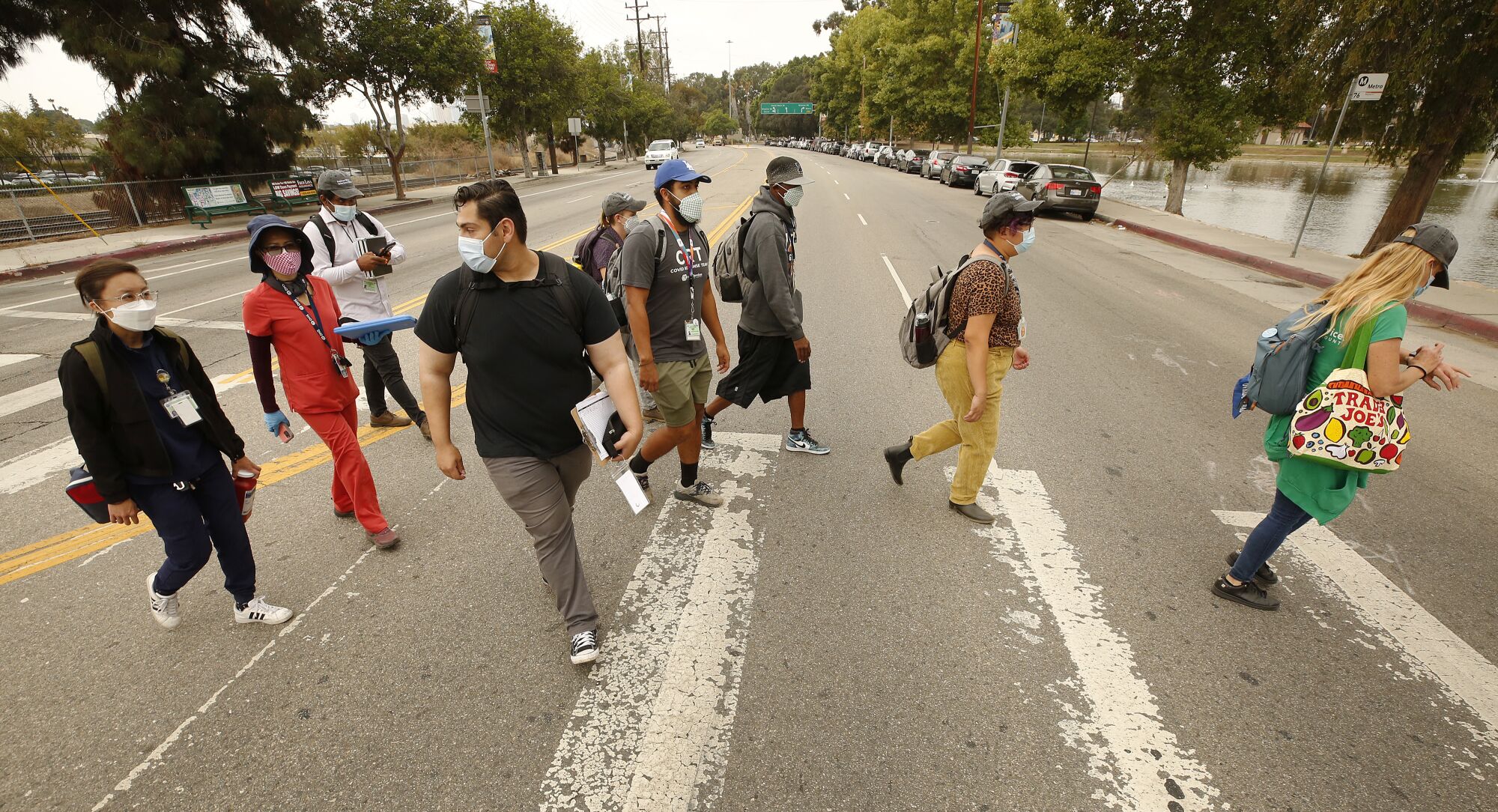 A group of people cross a street in Lincoln Park.