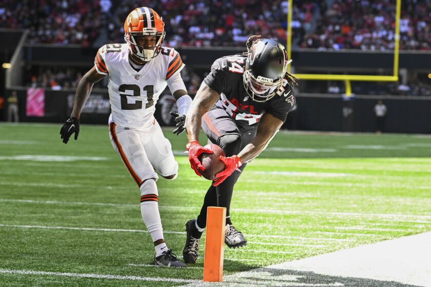 Atlanta Falcons running back Cordarrelle Patterson (84) runs in a touchdown against Cleveland Browns cornerback Denzel Ward (21) during the first half of an NFL football game, Sunday, Oct. 2, 2022, in Atlanta. (AP Photo/John Amis)