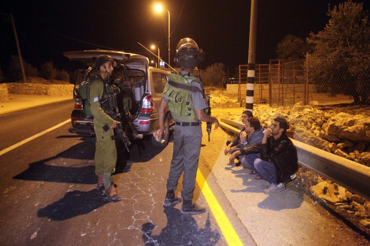 Israeli police cordon off the area and stop Palestinians after closing this road in south Hebron near Yatta village on November 26, 2013.