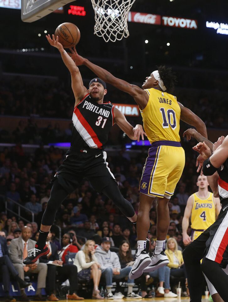 Lakers forward Jemerrio Jones (10) blocks a shot attempt by Portland Trail Blazers guard Seth Curry.