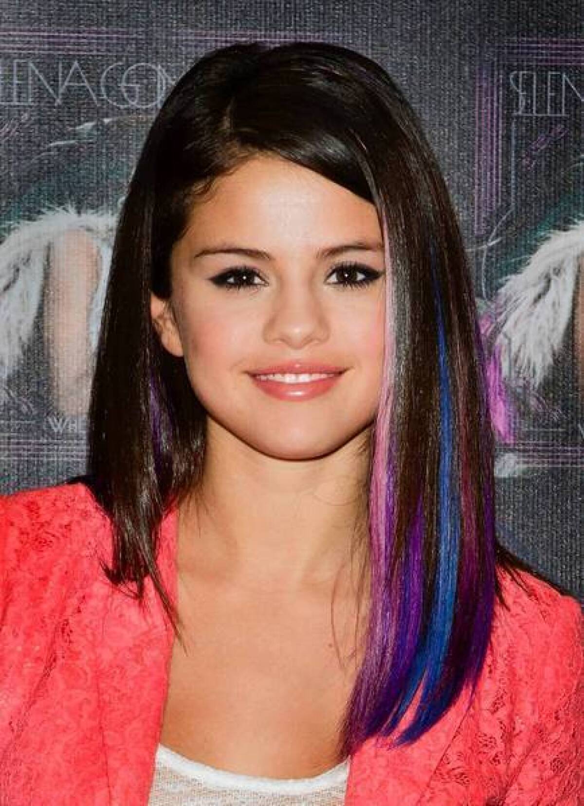 Singer Selena Gomez sports jewel-toned streaks in her smooth 'do.