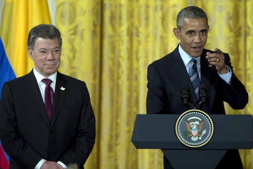 President Obama, with Colombian President Juan Manuel Santos, speaks at a reception for Plan Colombia, the U.S. aid program for Colombia, in the White House on Thursday.
