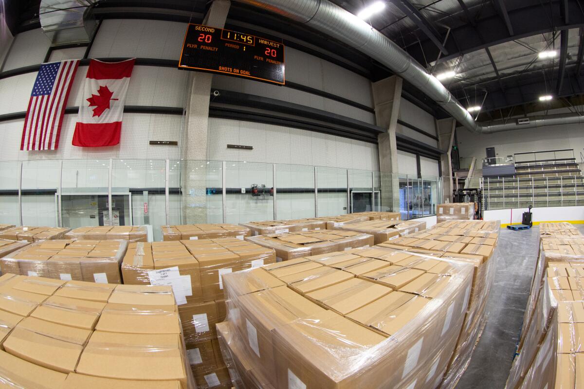 Boxes full of supplies are moved onto a rink at Great Ice Park in Irvine.