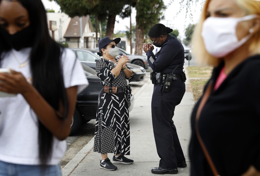 Emada Tingirides chats with Augie Lopez with the Housing Authority of the City of Los Angeles.