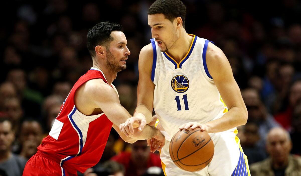 Clippers guard J.J. Redick forces Warriors guard Klay Thompson to drive instead of attempt a three-point shot during their Christmas Day game.