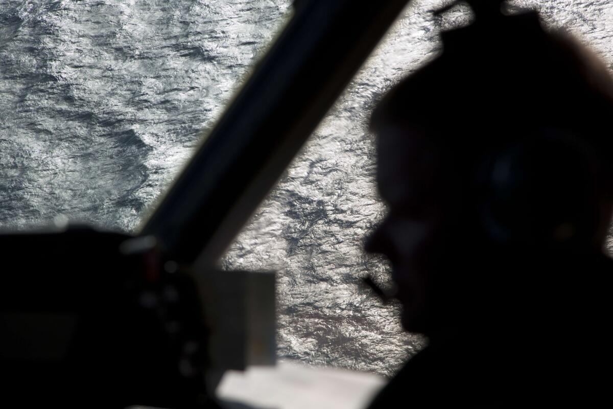 Captain Peter Moore is silhouetted against the southern Indian Ocean aboard a Royal Australian Air Force AP-3C Orion aircraft searching for the missing Malaysia Airlines flight 370 over the southern Indian Ocean on Thursday.