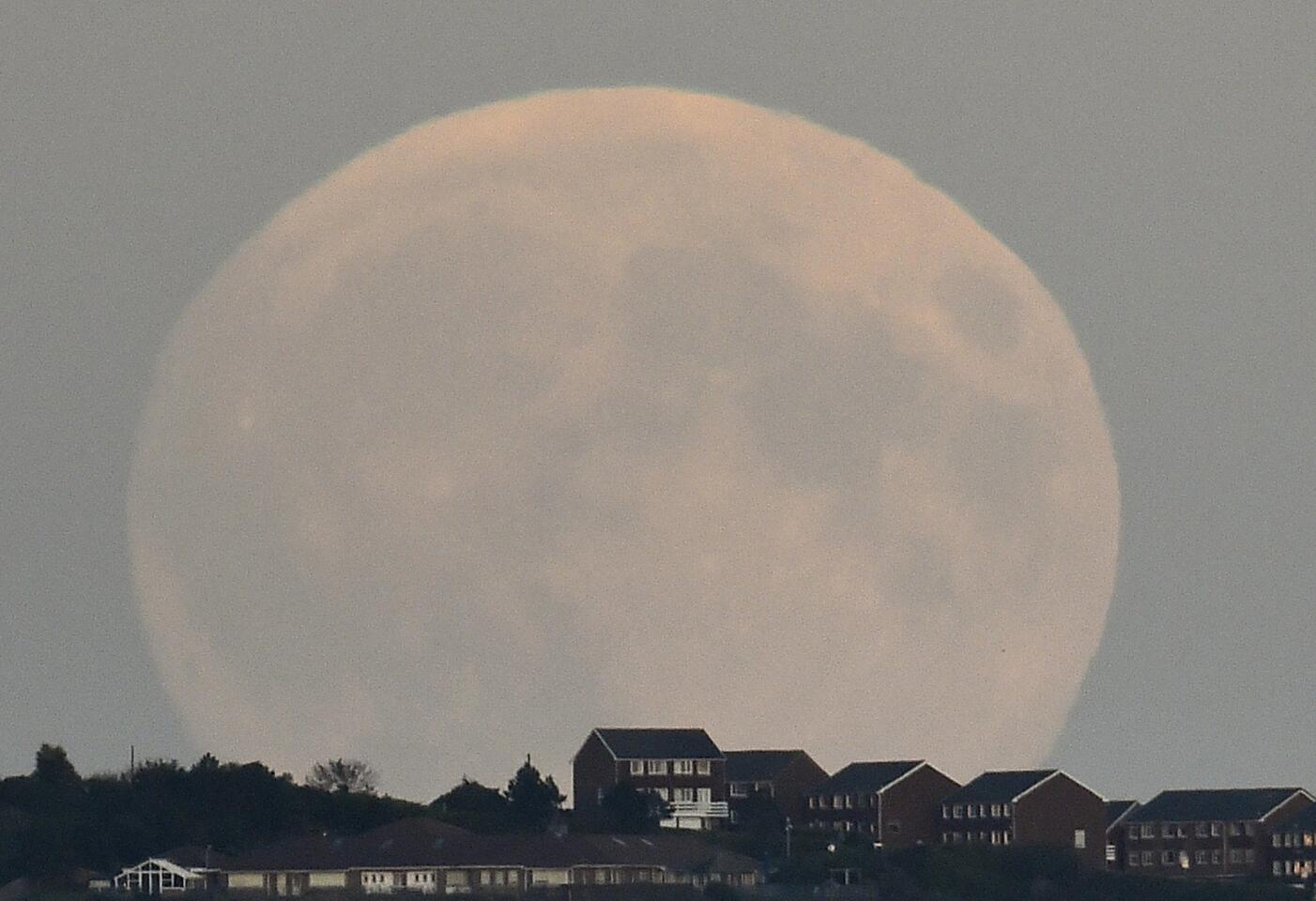 A "supermoon'' rises above Brighton in southern England