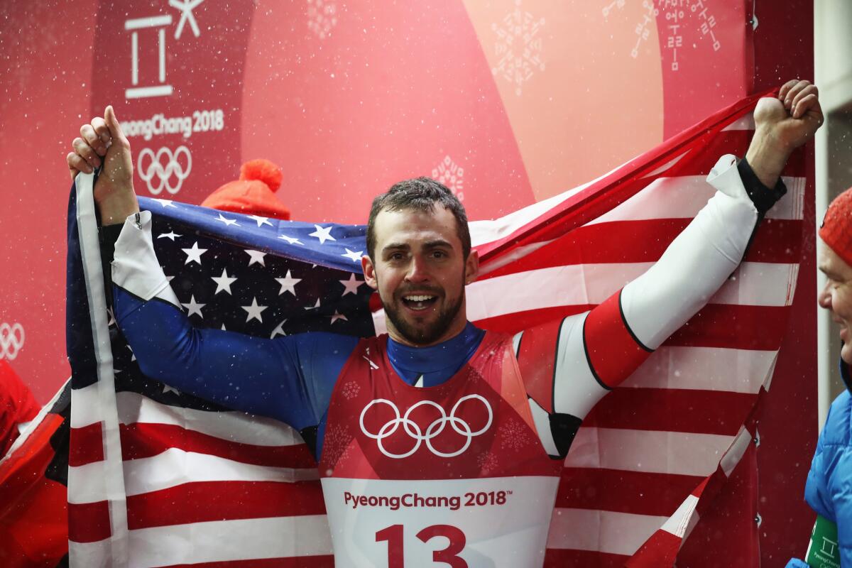 Chris Mazdzer of the United States celebrates winning the silver medal.