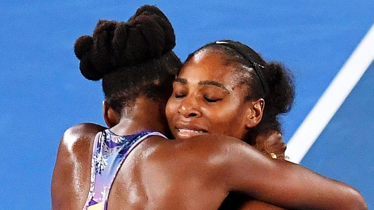 Serena Williams (right) is congratulated by her sister Venus Williams (left) after winning the women's final at the Australian Open Grand Slam in Melbourne.