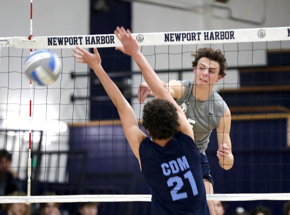 Newport Harbor's Riggs Guy (5) kills a ball during the Battle of the Bay game against Corona del Mar on Friday.