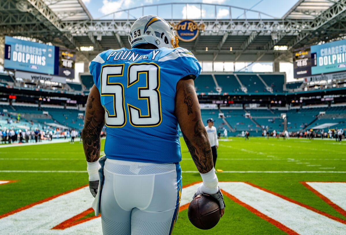 Chargers center Mike Pouncey warms up before a game against the Dolphins on Sept. 29.