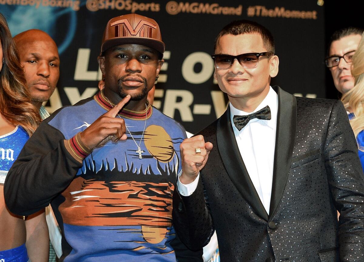 WBC welterweight champion Floyd Mayweather Jr., left, and WBA champion Marcos Maidana, right, will face each other in the ring on Saturday at the MGM Grand Garden Arena.