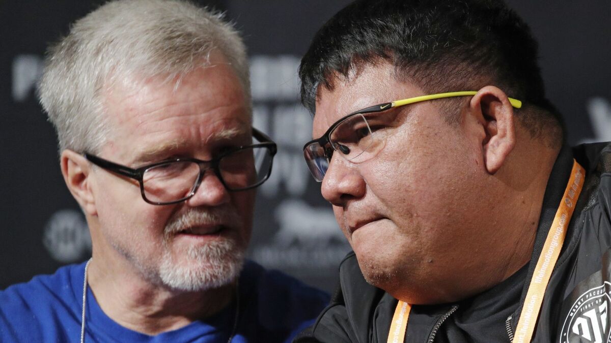 Buboy Fernandez, right, and Freddie Roach speak at a news conference for an upcoming fight between Manny Pacquiao and Adrien Broner on Wednesday in Las Vegas.