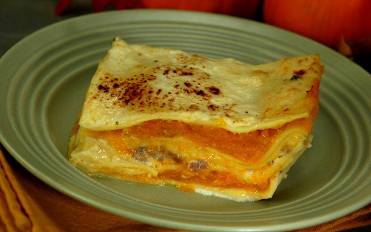 A slice of pumpkin lasagna shows the layers of pumpkin, noodles and cheese.