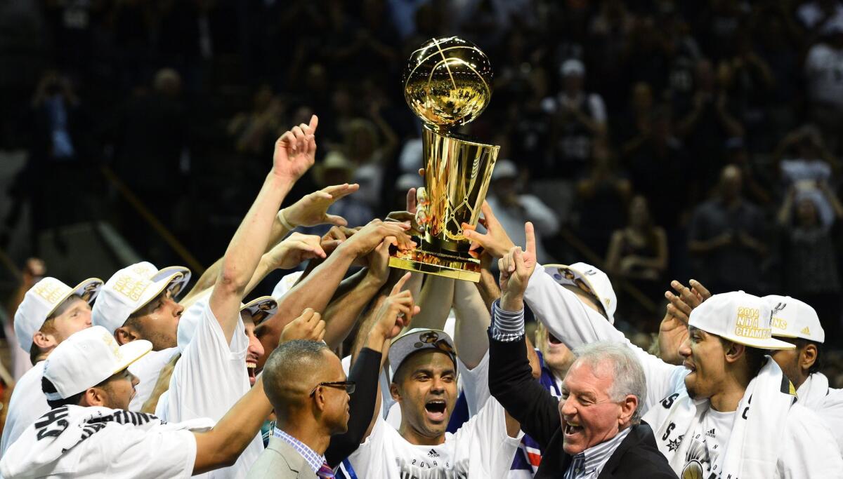 San Antonio Spurs players celebrate winning the NBA championship.