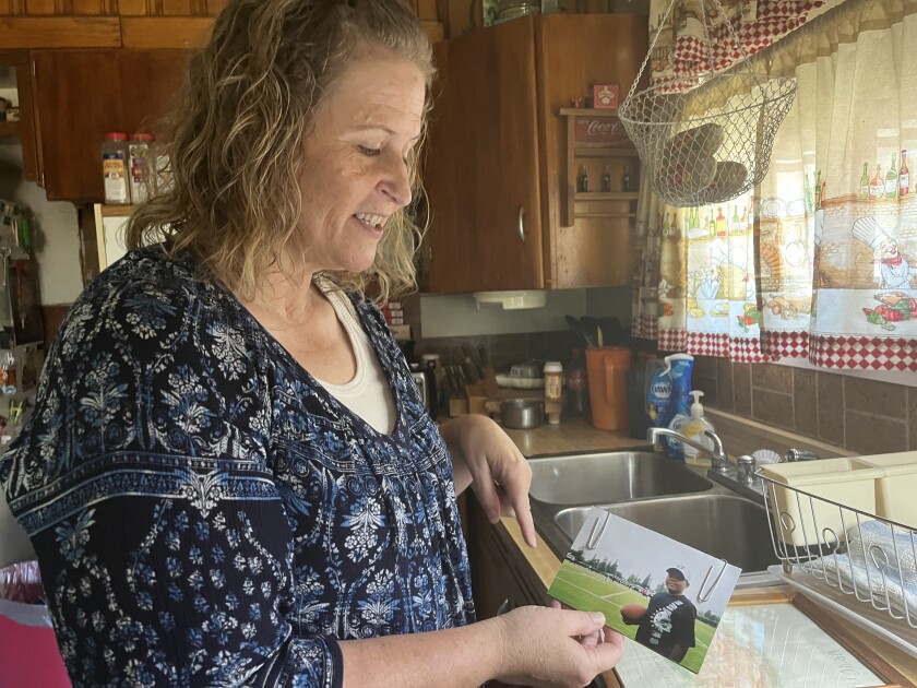 Brandi Michalik holds a picture of her son, Neven Butler.