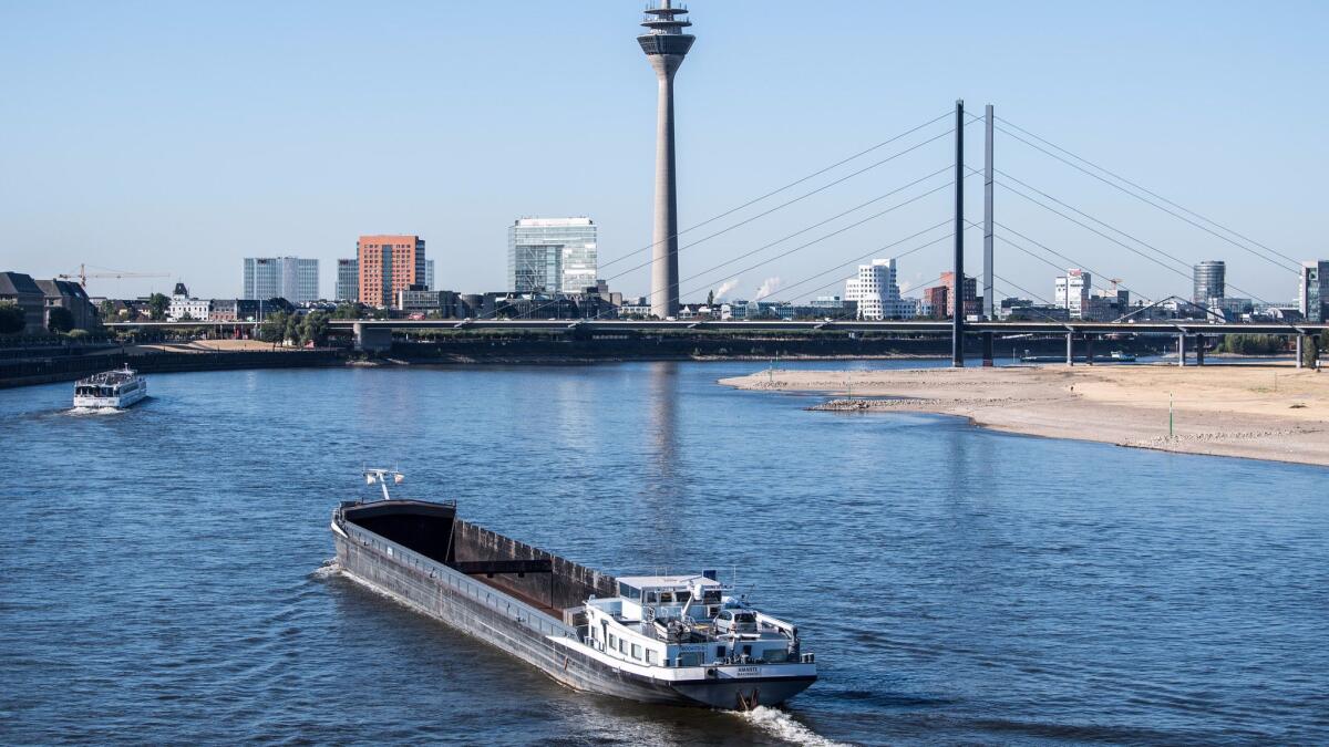 A barge sails on the Rhine River on Aug. 6 in Duesseldorf, Germany. Europe's continuing drought and low water levels are limiting travel by some cargo and river cruise ships.