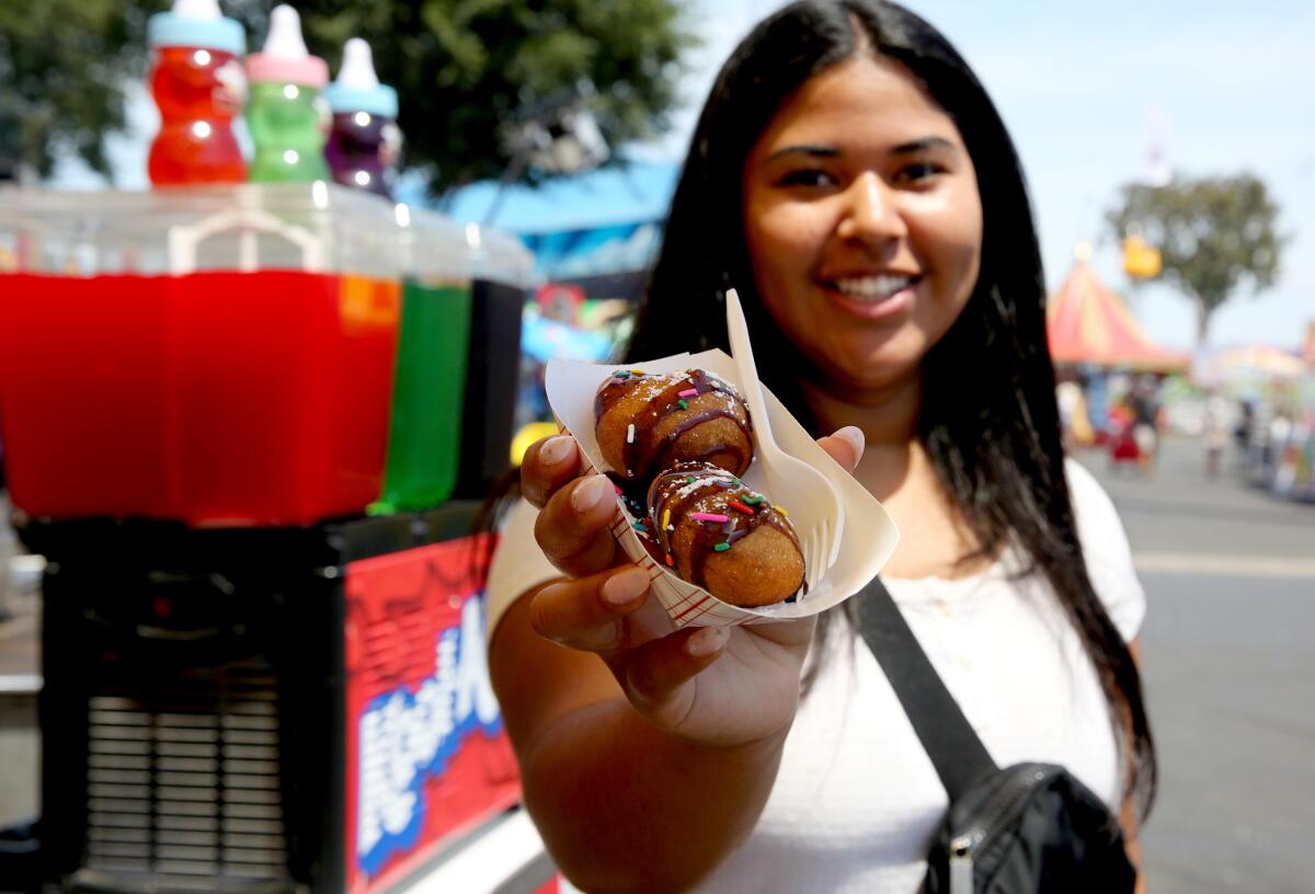 Nancy Serrano, 18 of Costa Masa, shows the deep-fried Oreo cookies she ordered from Chicken Charlie's.