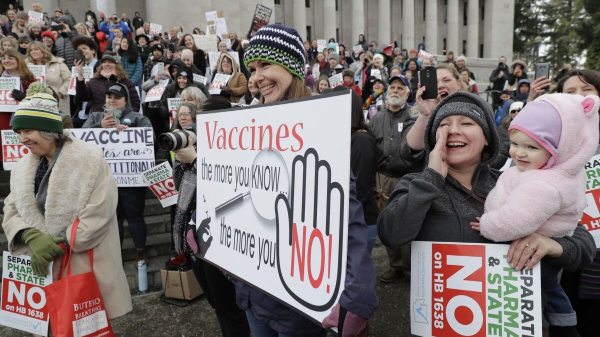 Protesters in Olympia, Wash., express their opposition to a bill that would prevent parents from claiming a philosophical exemption to the measles, mumps and rubella vaccine.