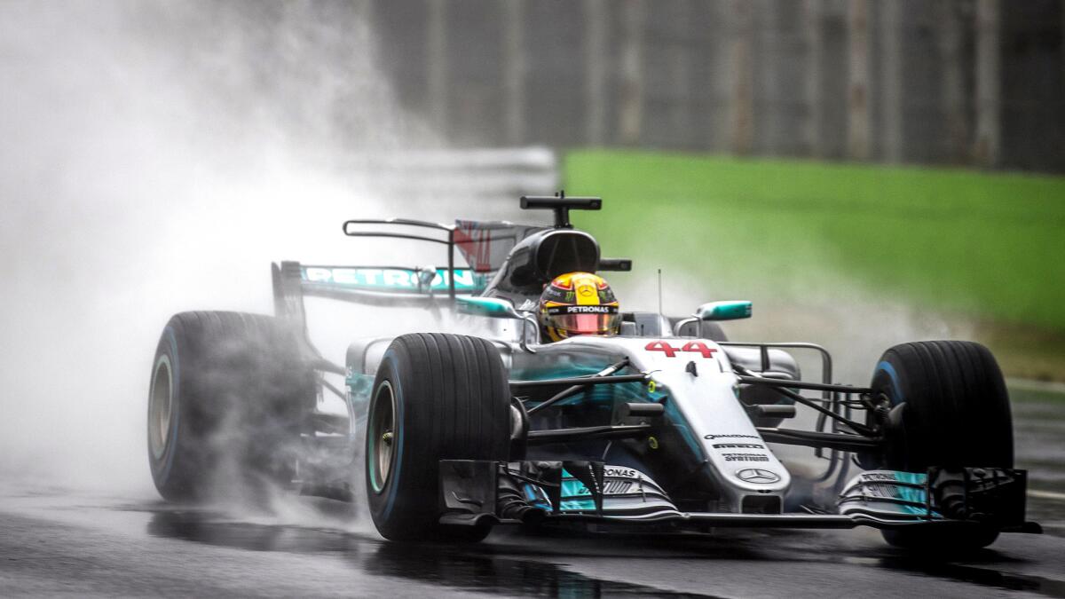 Formula One driver Lewis Hamilton negotiates a wet track during qualifying for the Italian Grand Prix on Saturady in Monza.