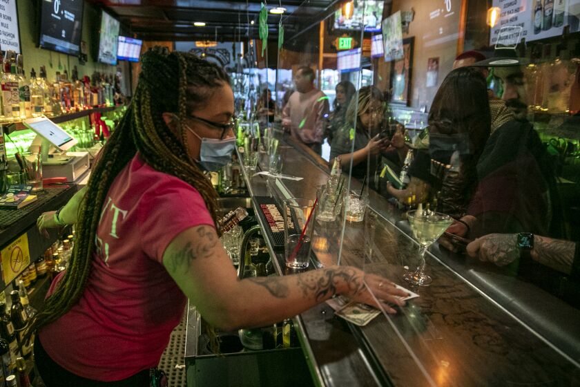 Covina, CA, Sunday, June 28,2020 - Bartender Christina Flintland serves drinks at Elvie's Public House. Governor Newsom orders bars to close as Covid-19 cases surge in California. (Robert Gauthier / Los Angeles Times)