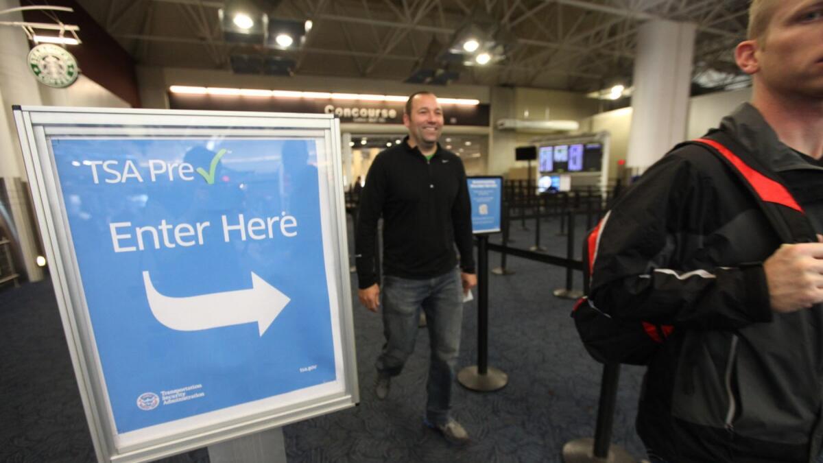 Passengers walk through the PreCheck lane at Milwaukee's Mitchell International Airport on Oct. 22, 2013.