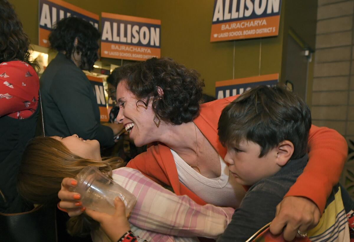 Allison Bajracharya shares a moment with her daughter Mary, 10, and son, Leo, 7, during an election night gathering in Silverlake.
