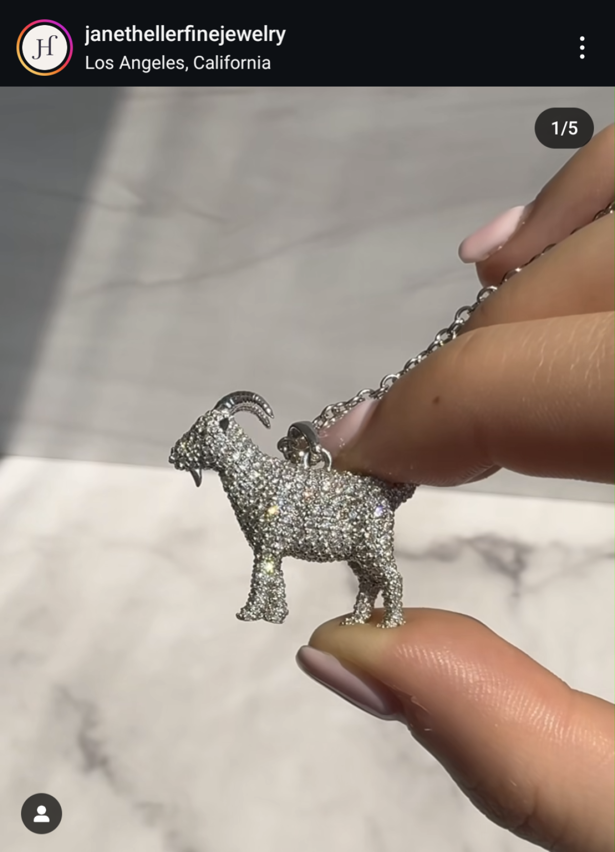 A photo shows the diamond-encrusted goat pendant created for Olympic star Simone Biles by Jane Heller Fine Jewelry