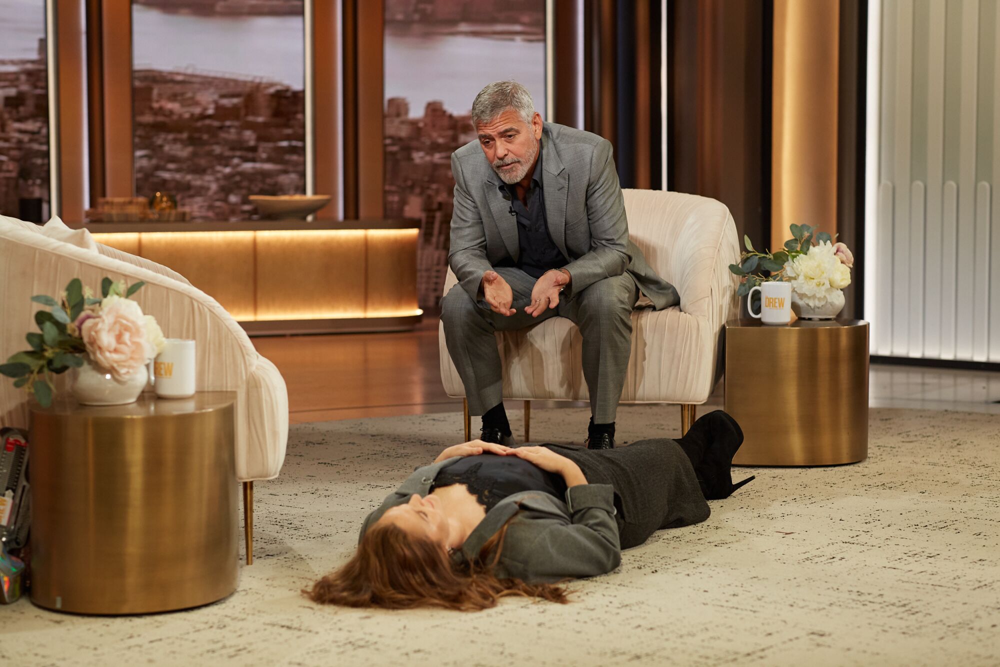 George Clooney acts as Barrymore's therapist while she lies on the floor of her set.