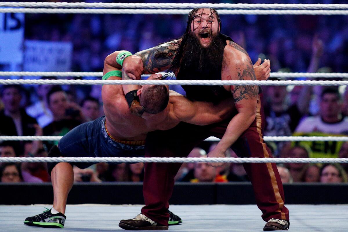 John Cena, left, and Bray Wyatt, right, compete during Wrestlemania XXX.