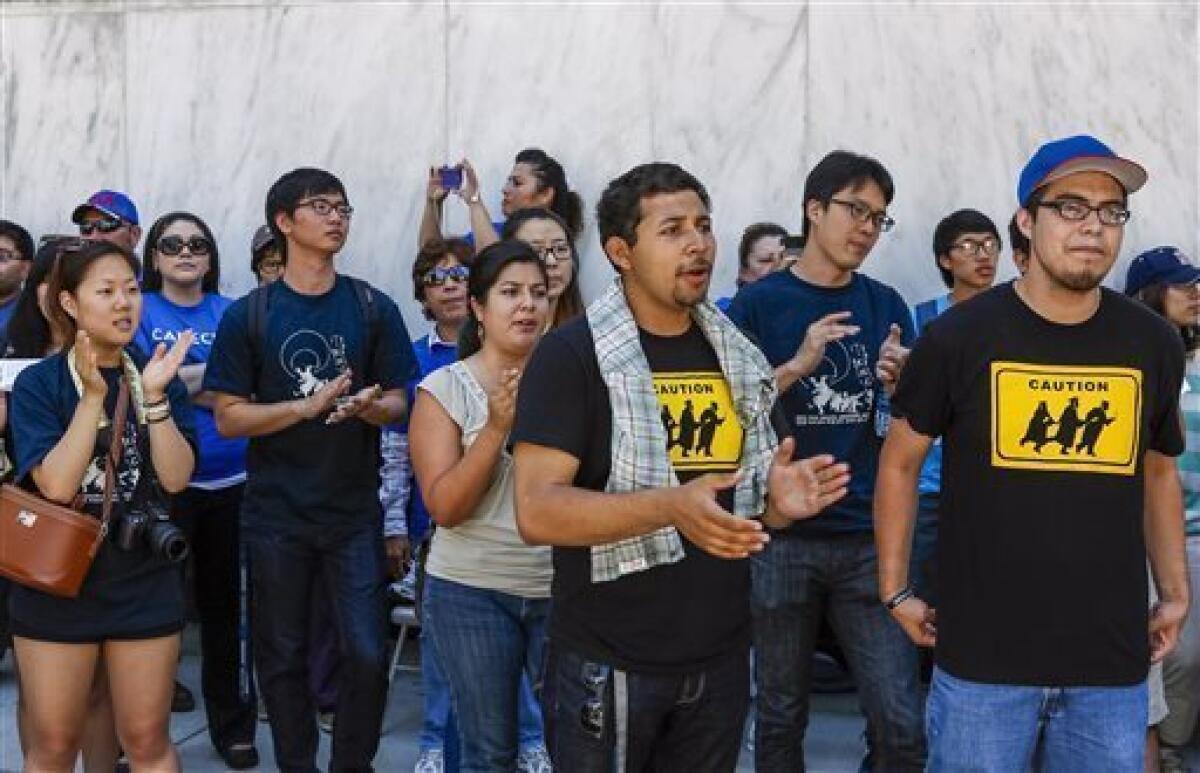 Immigrant students hold a vigil outside the West Los Angeles Federal Building last month calling on Congress to pass the immigration overhaul.