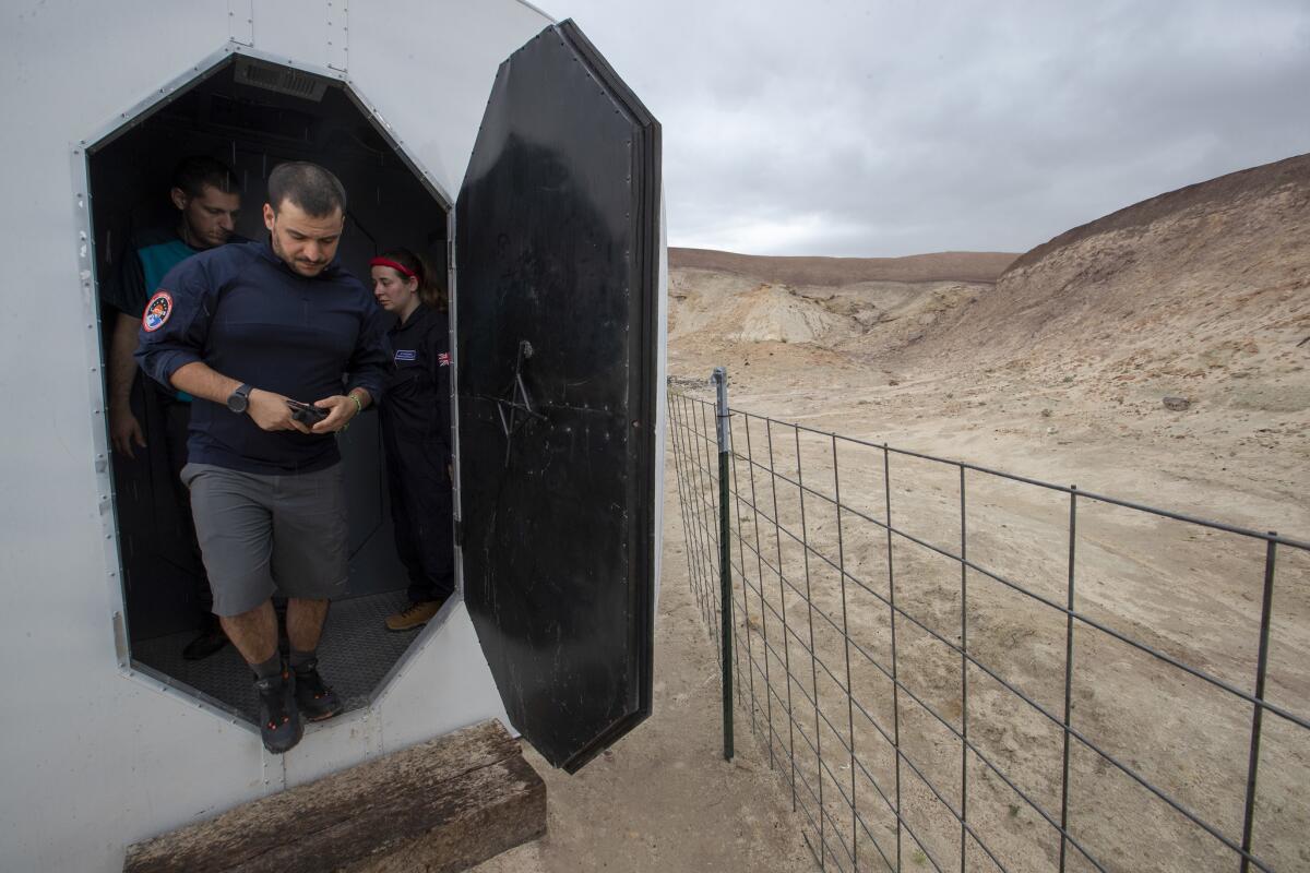 Vittorio Netti leaves the crew module on his way to the science dome as part of an international crew manning the Mars Society's Mars Desert Research Station near Hanksville, Utah.