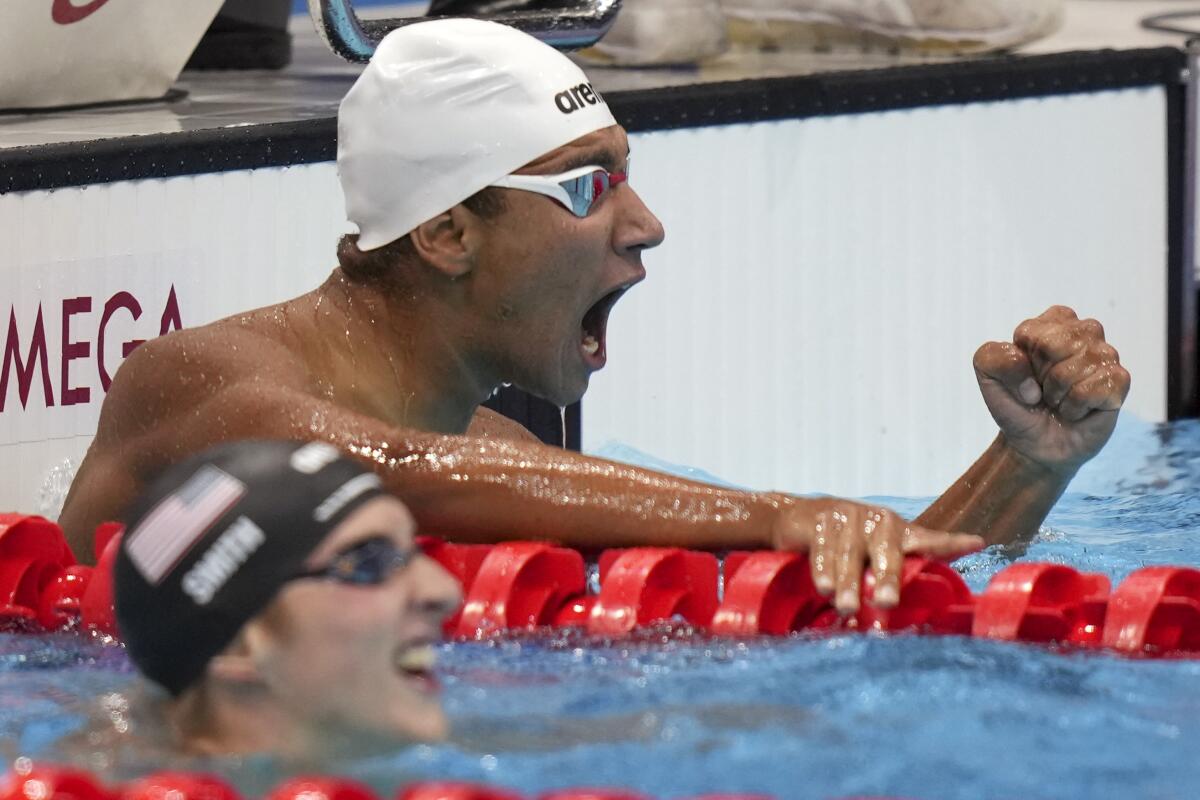 Tunisia's Ahmed Hafnaoui celebrates after winning the men's 400-meter freestyle.