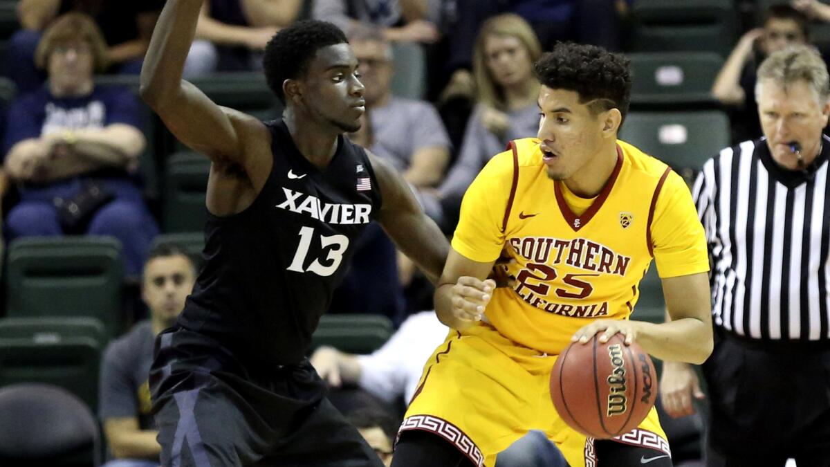 USC forward Bennie Boatwright (25) works in the post against Xavier forward Makinde London during a game Nov. 27.