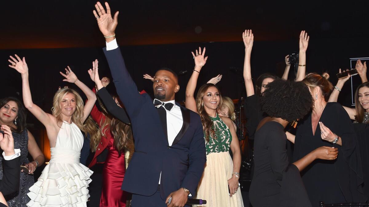 Jamie Foxx, center, welcomes the crowd at the Learning Lab Ventures' winter gala in partnership with luxury online retailer Net-a-Porter on Jan. 25 in Beverly Hills.