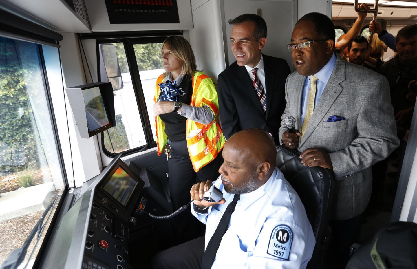 Mayor Eric Garcetti and Los Angeles County Supervisor Mark Ridley-Thomas watch train operator William Smith during an Expo Line test run between the Culver City Station and downtown Santa Monica on May 9.