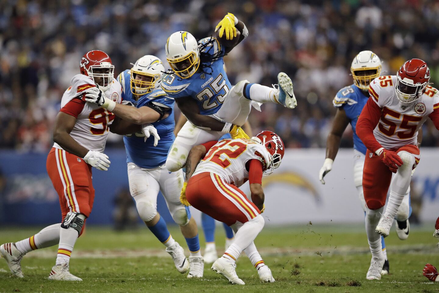 Chargers running back Melvin Gordon leaps over Chiefs strong safety Tyrann Mathieu during the first half of a game Nov. 18 at Estadio Azteca in Mexico City.