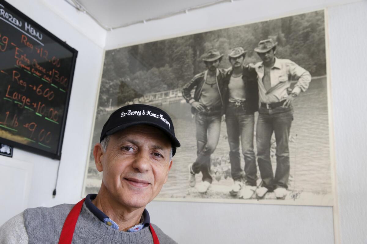 Grant Yegiazaryan is shown with a photo of himself as a young man (at right) with his two friends at the Black Sea in Soviet Russia in 1978, before he immigrated to the U.S. where he, his wife and son run the manti-making Monta Factory in Pasadena.