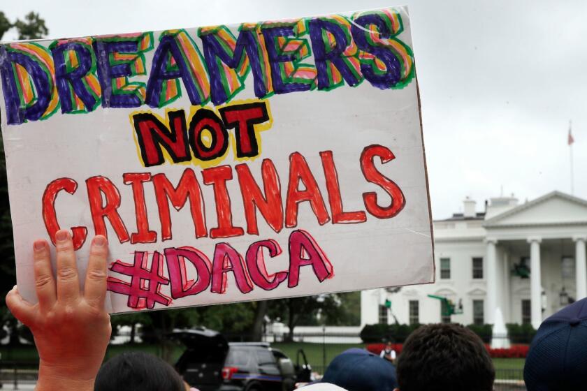 A woman holds up a signs in support of the Obama administration program known as Deferred Action for Childhood Arrivals, or DACA, during an immigration reform rally, Tuesday, Aug. 15, 2017, at the White House in Washington. The Trump administration has said it still has not decided the program's fate. (AP Photo/Jacquelyn Martin)