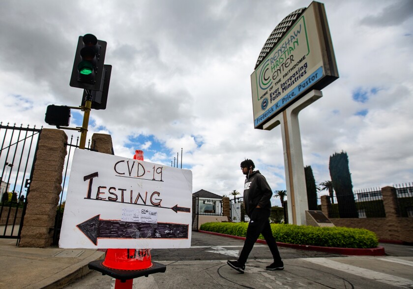 People are directed to a drive-through coronavirus testing site at Crenshaw Christian Center in Los Angeles.